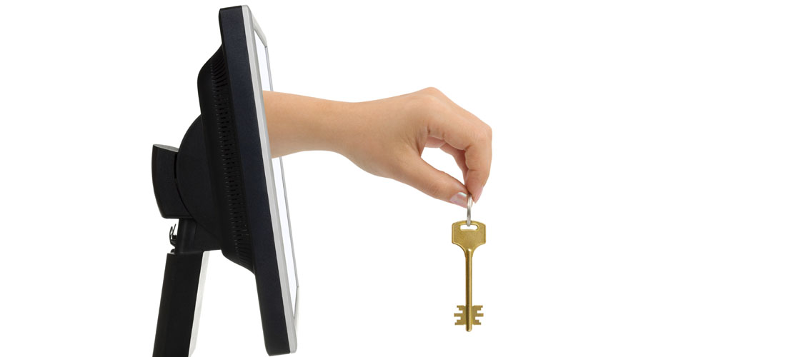 Computer screen and hand with key